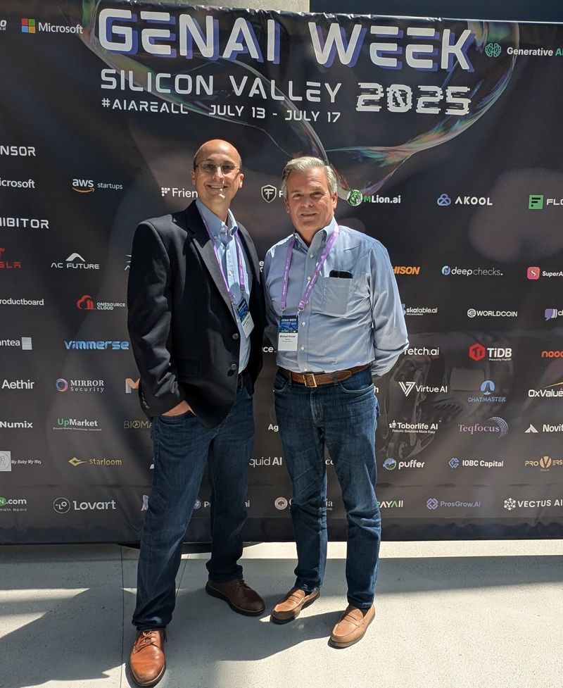 Matt Phillips and Michael Dimler standing in front of the GenAI Week Silicon Valley 2025 banner, July 13 to July 17.